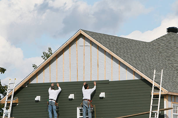 Professional Siding Installation technician working in Brookville, NY